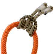 Close-up of a prusik knot tied with durable orange and tan climbing lanyards, used for arborist, rescue, and climbing safety applications.